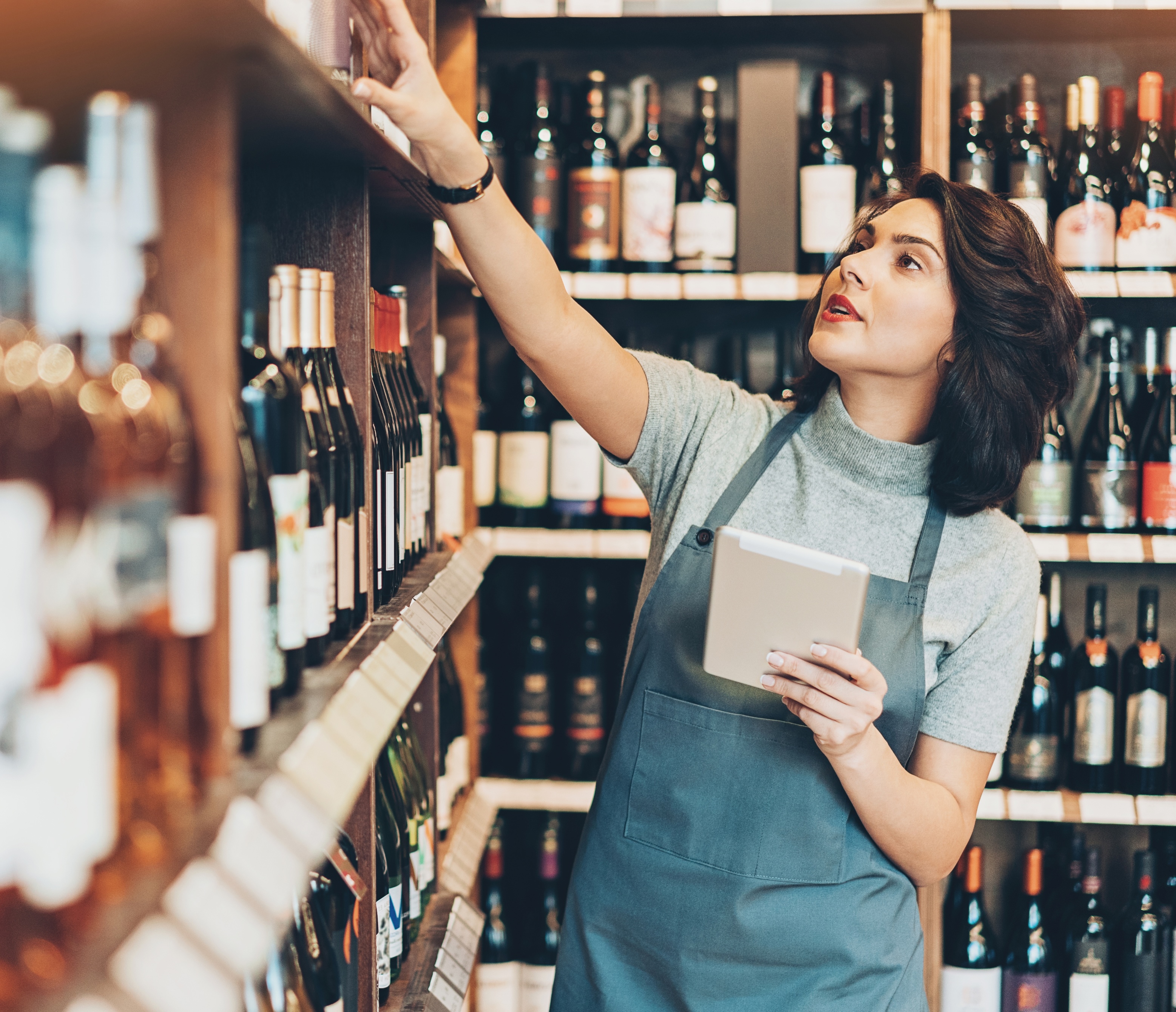 Woman looking at shelves of wine